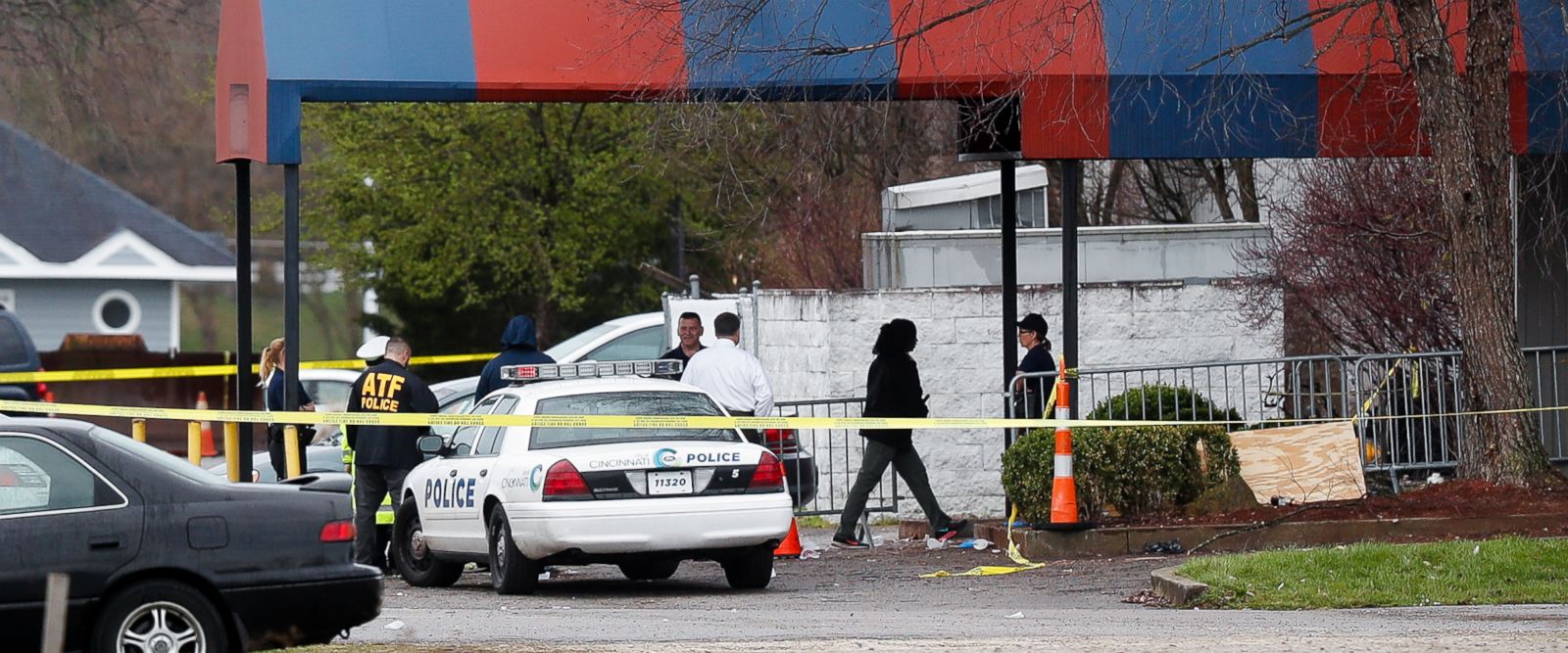 Members of the ATF and local police work at a crime scene at the Cameo club after a fatal shooting, Sunday, March 26, 2017, in Cincinnati. (AP Photo/John Minchillo)
